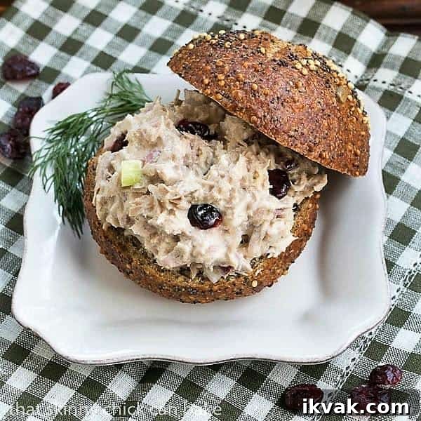 Tuna, Cranberry, Pecan Salad Sandwich - a quick lunch recipe for a delicious change of pace! Tuna, Cranberry, Pecan Salad Sandwich on a white plate