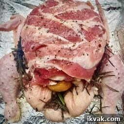 Christmas Chicken ready for the oven covered in streaky bacon