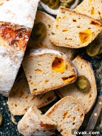 gluten free jalapeño cheddar bread with sharp cheddar and pickled jalapenos, sliced, on a sheet tray