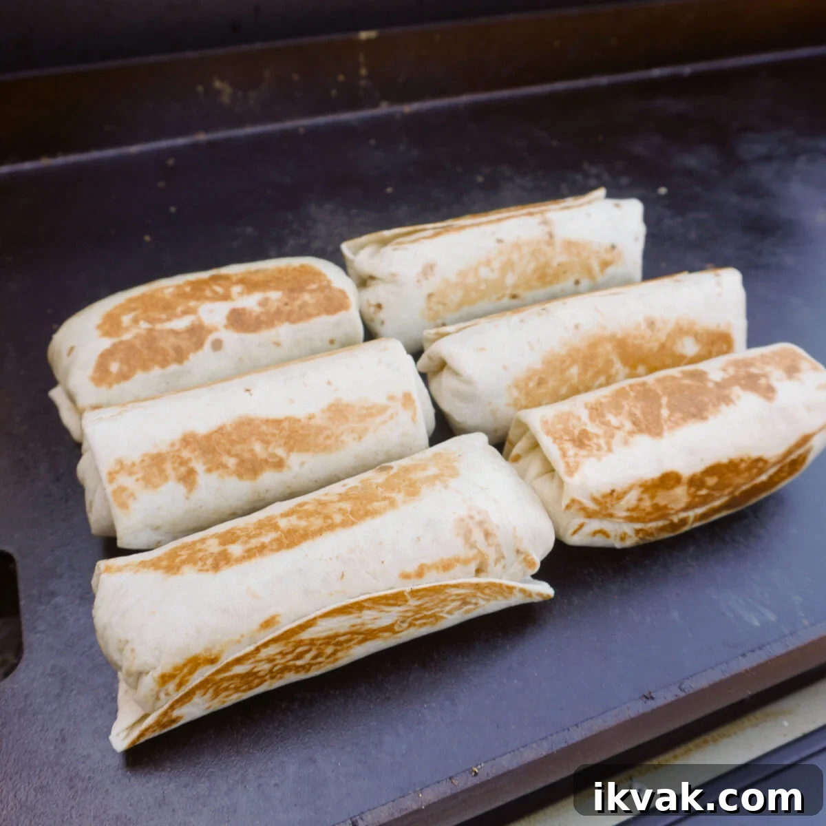 breakfast burritos toasted on the griddle.