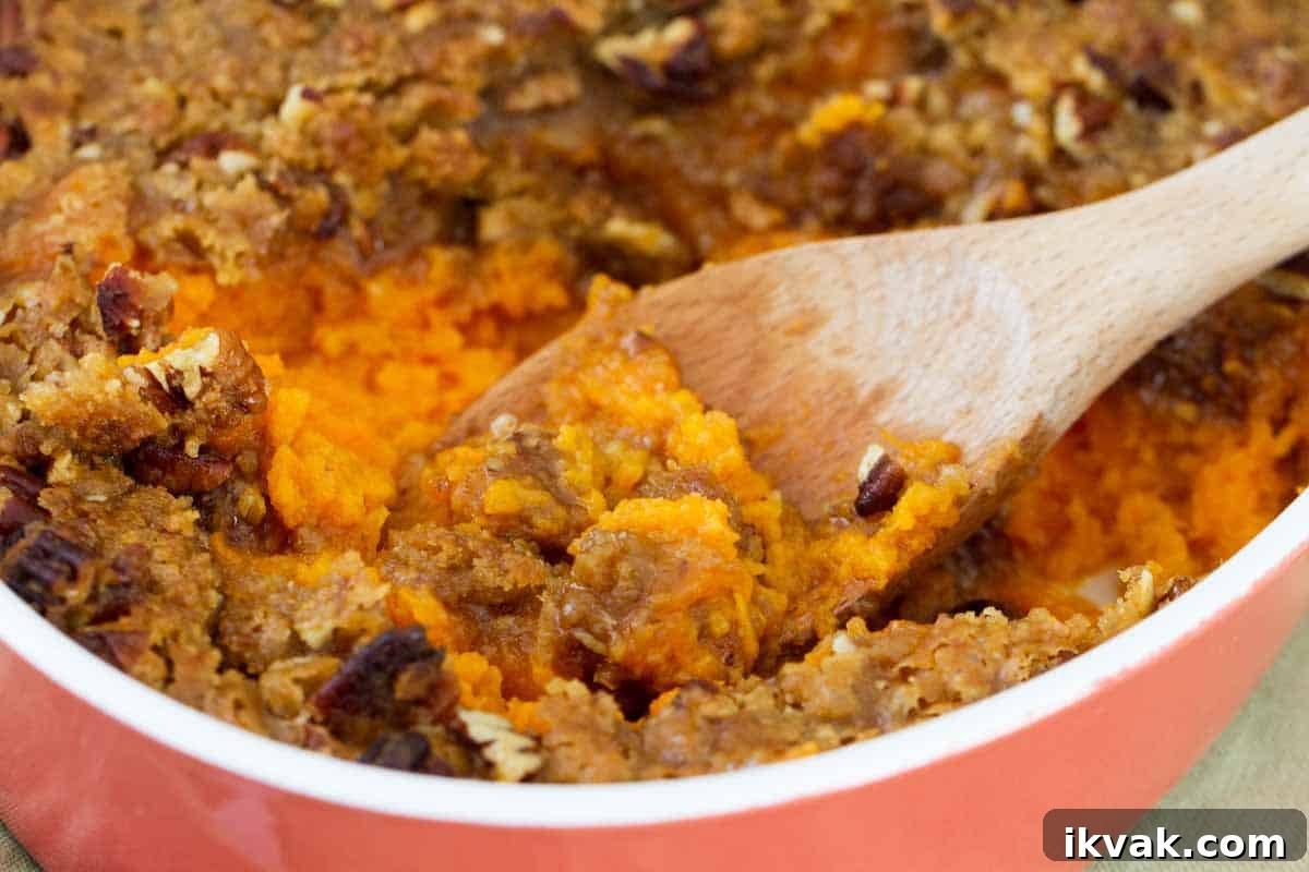 A sweet and decadent side dish, this really is the BEST Sweet Potato Casserole. It is perfect for the holidays! casserole dish with sweet potato casserole