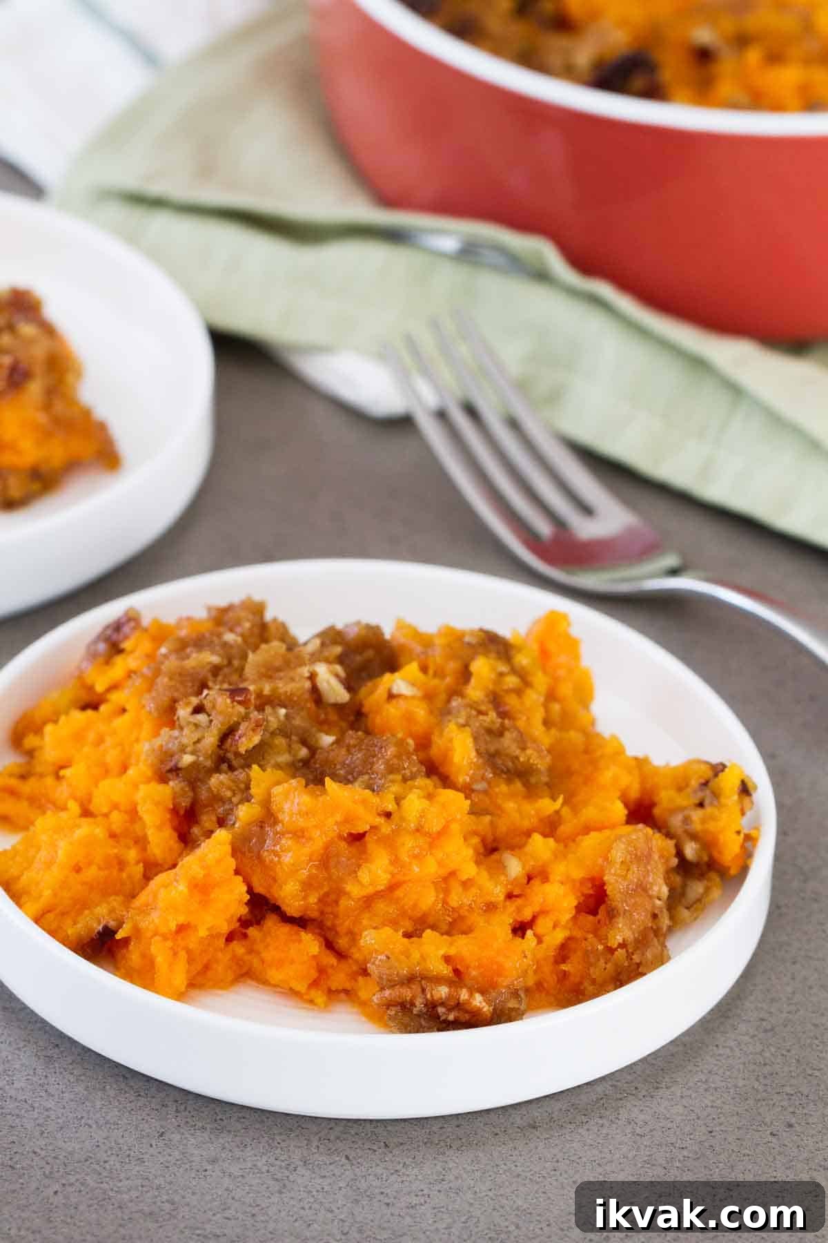 A sweet and decadent side dish, this really is the BEST Sweet Potato Casserole. It is perfect for the holidays! Sweet potato casserole on a plate