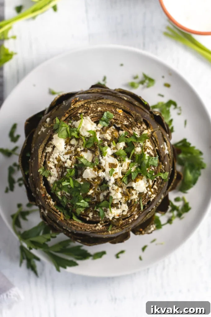 Mediterranean-Style Baked Artichokes with Lemon and Herbs 3 baked artichoke topped with feta and parsley