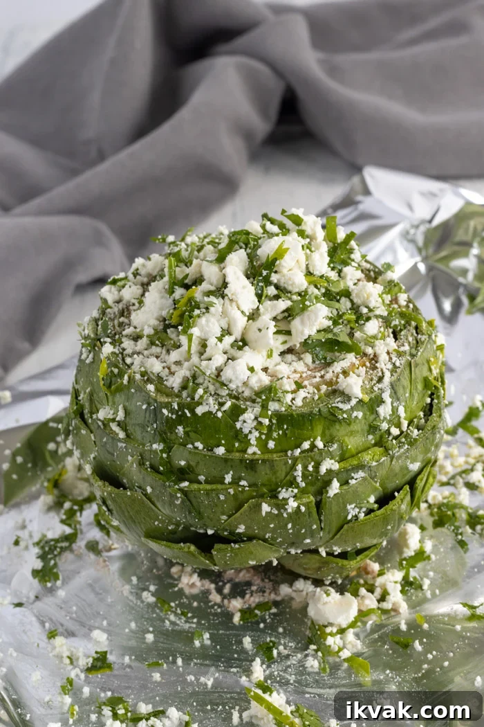 Mediterranean-Style Baked Artichokes with Lemon and Herbs 5 adding feta to an artichoke
