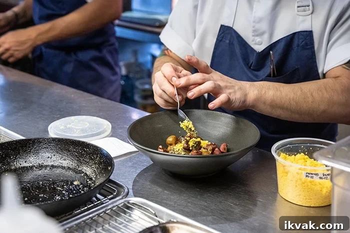 Plating one of the most popular dishes at El Chato, the Chicken hearts.