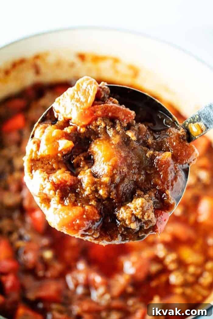 ladle with big scoop of keto chili over pot