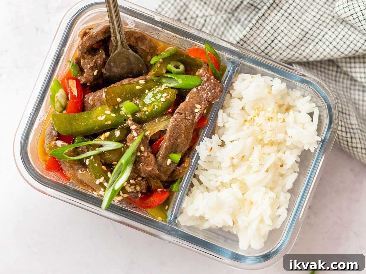 horizontal image showing a meal prep container filled with pepper steak and white rice