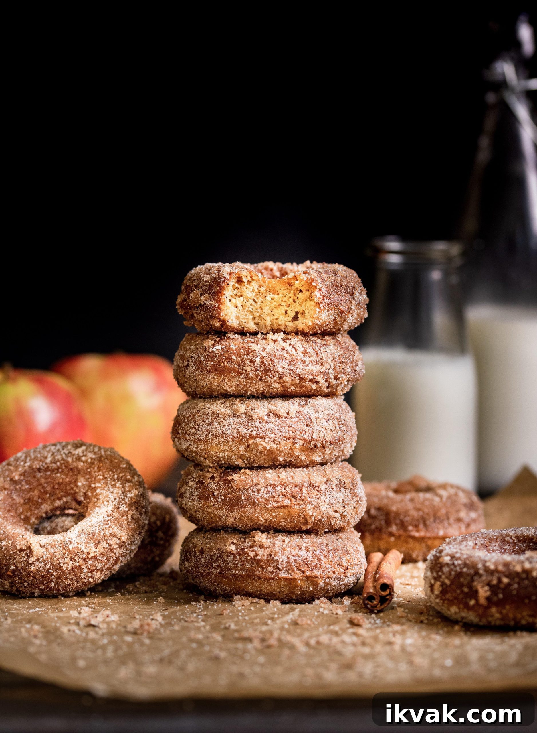 Cinnamon Apple Cider Baked Donuts Recipe 2 Baked Apple Cider Donuts stacked with bite out of top