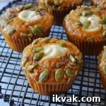 Pumpkin Cream Cheese Muffins with Swirled Filling Recipe 5 pumpkin copycat starbucks cream cheese muffins arranged at random on a black wire rack