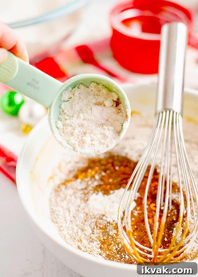 Pfeffernüsse: Traditional German Christmas Spice Cookies 7 Whisking ingredients in a bowl