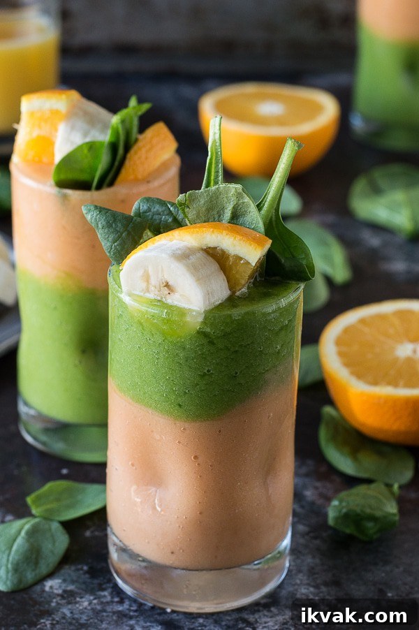 Two layer green monster orange smoothie - healthy and easy to make! Top the smoothie with a fruit skewer. 