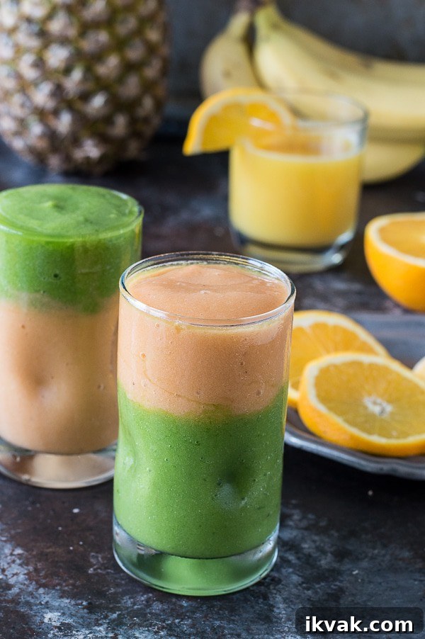 Two layer green monster orange smoothie - healthy and easy to make! Top the smoothie with a fruit skewer. 