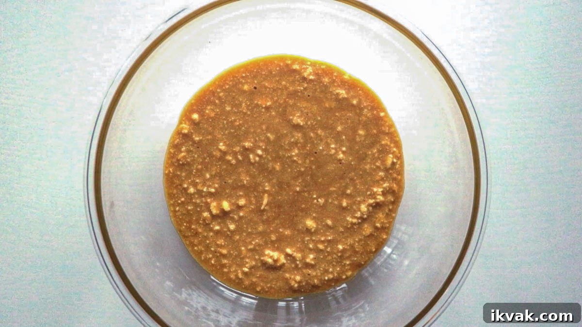 Some of the ingredients for this cookie recipe combined in a glass bowl.