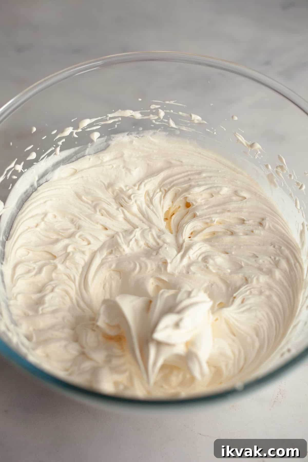A large glass bowl with whipped cream.