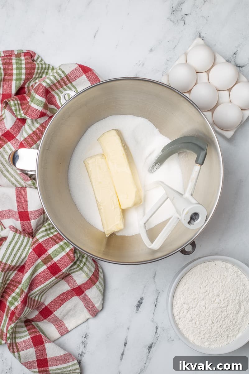 Butter and sugar in mixing bowl with paddle attachment from stand mixer.