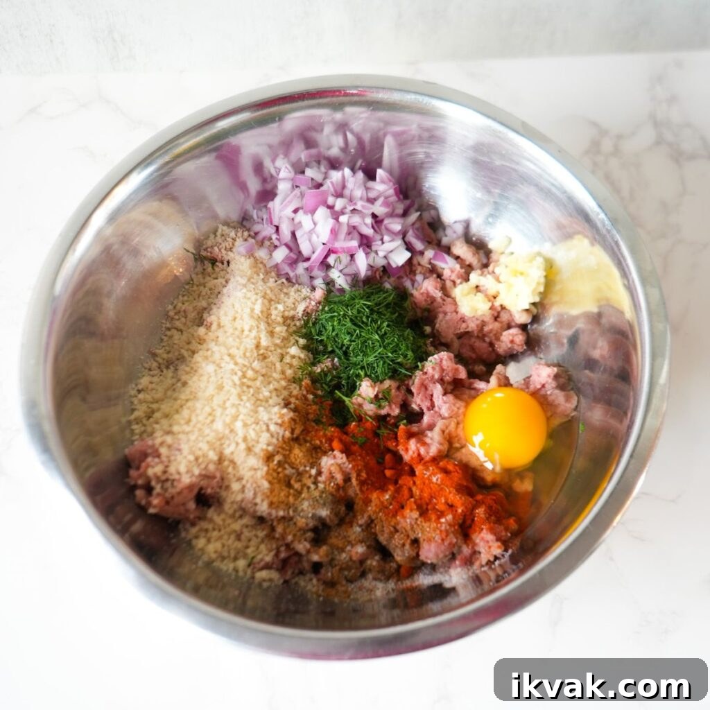 Ground turkey, panko breadcrumbs, red onion, dill, egg, garlic, and seasonings in a mixing bowl.