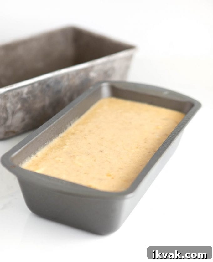 Metal loaf pan filled ⅔ full with banana bread batter