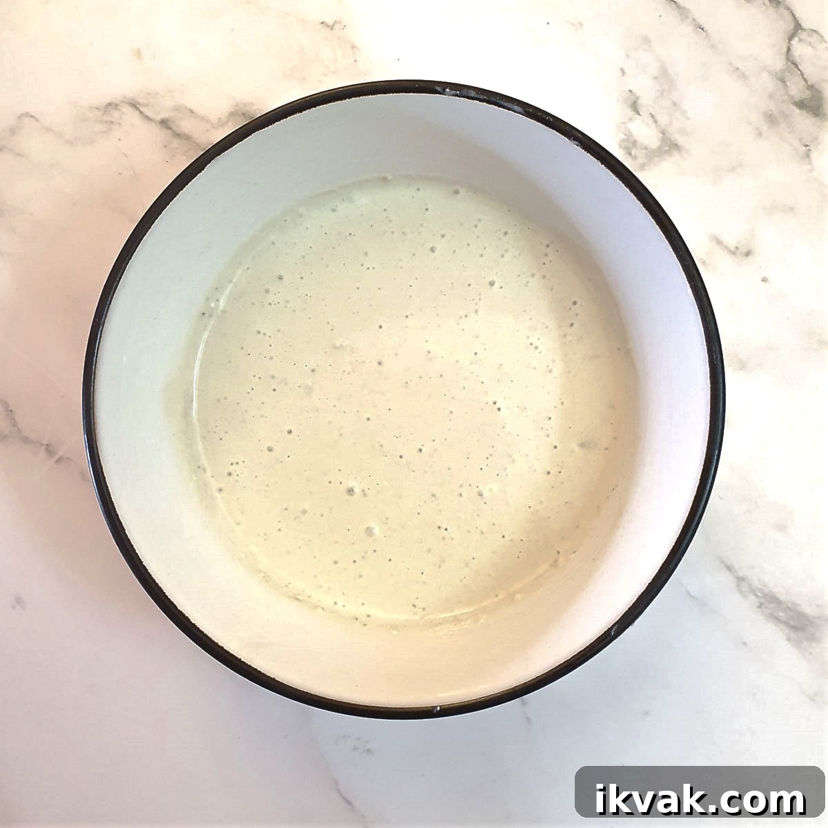 A bowl of blue cheese sauce after it has been mixed.