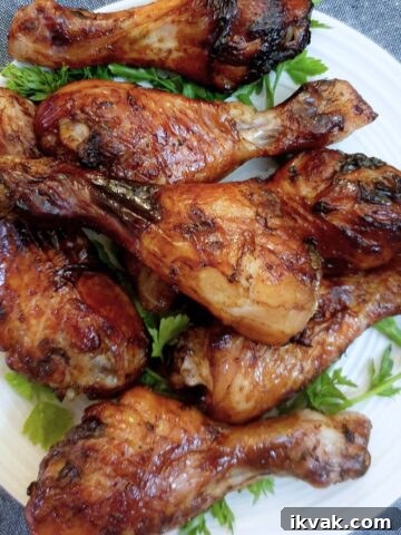 A pile of sweet and spicy chicken drumsticks on a plate.