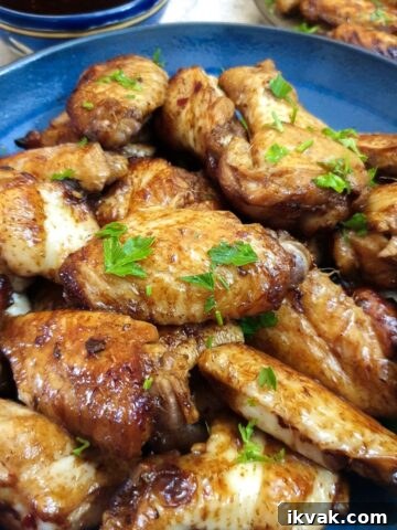 Close up of a blue dish containing honey-glazed chicken wings.