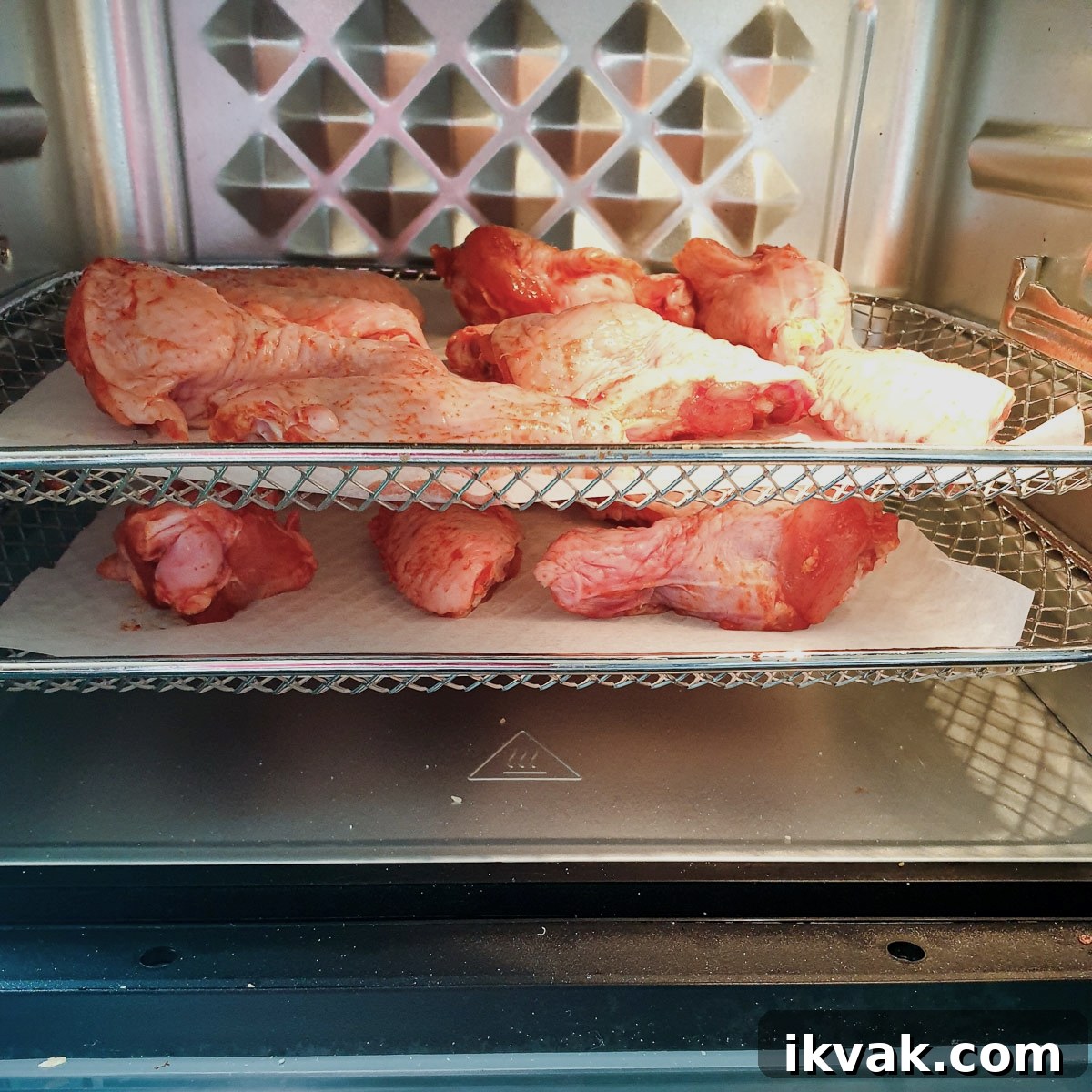 Chicken wings on the trays in an air-fryer oven.