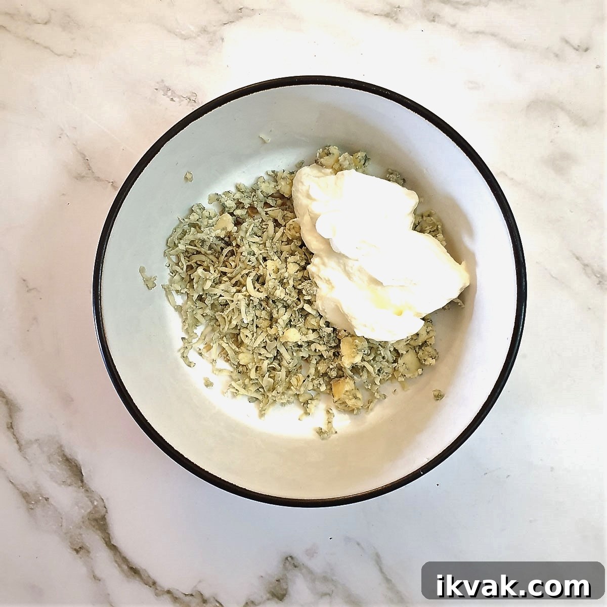 Ingredients for blue cheese sauce in a small mixing bowl.
