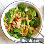 Healthy tuna pasta salad in a serving bowl with serving spoons.