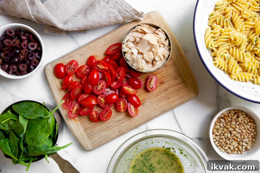 All of the ingredients for the healthy tuna pasta salad recipe arranged on a countertop. 