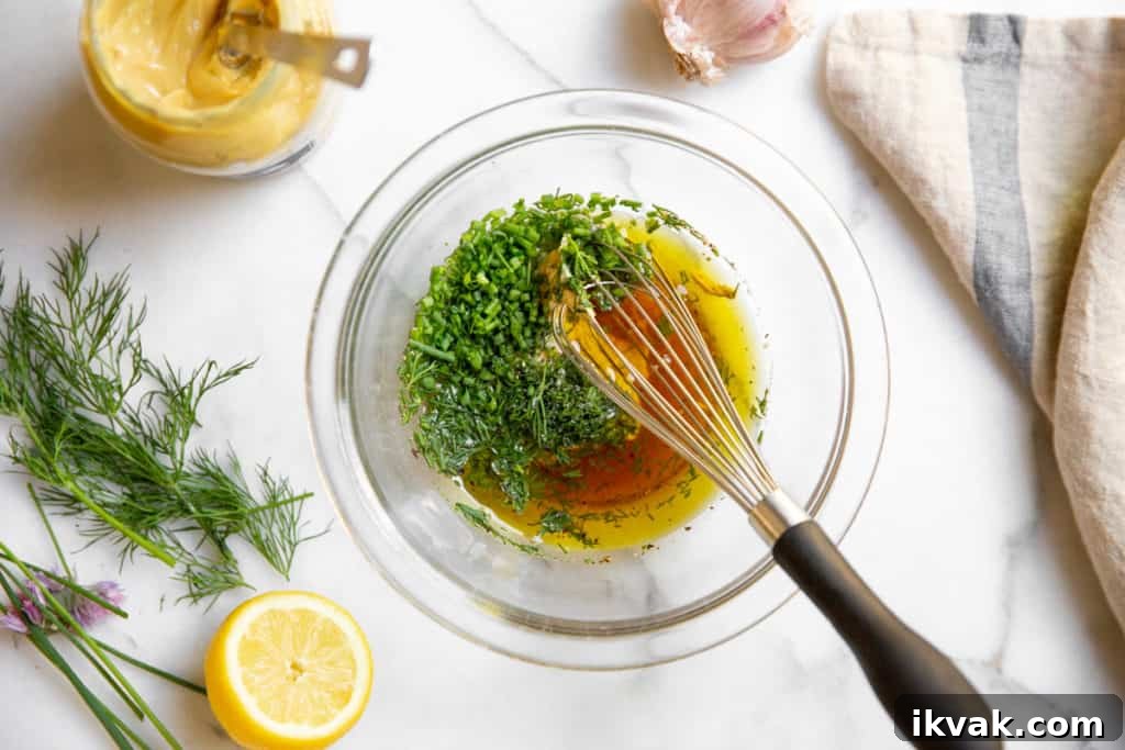 All of the ingredients for the Dijon dill dressing in a bowl. 
