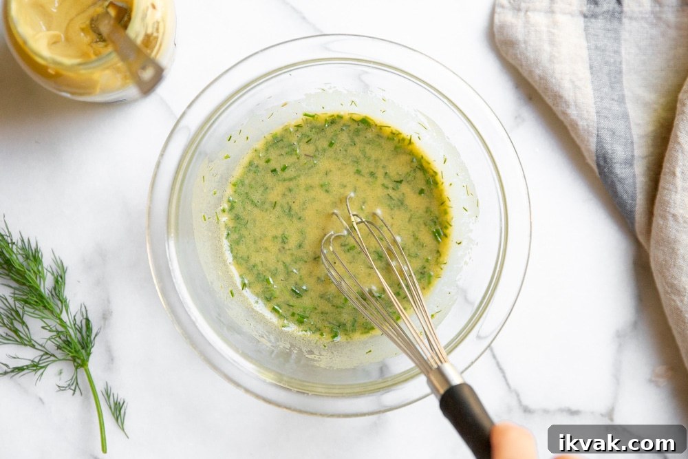 Dijon dill dressing whisked together in a bowl.