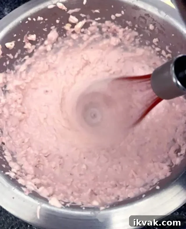 mixing strawberry cheesecake fat bomb