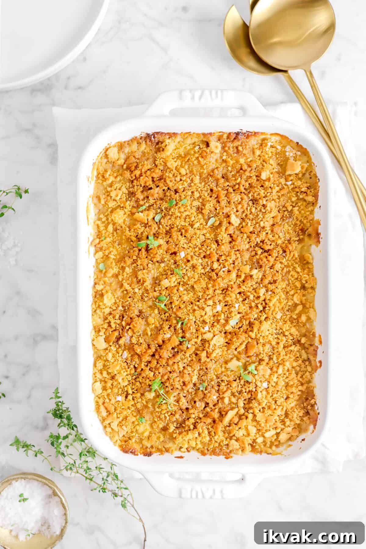 shoepeg corn and green bean casserole with two gold spoons and thyme