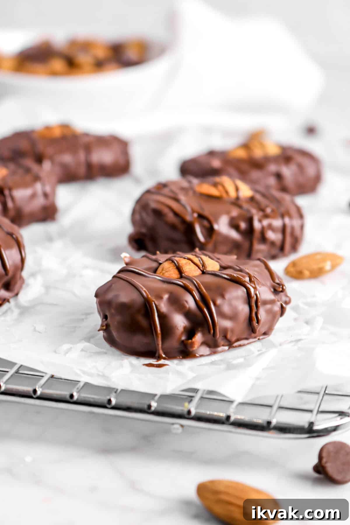 almond joys on parchment with almonds and chocolate chips