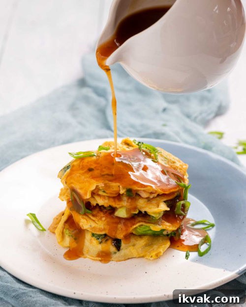 Keto Egg Foo Young Recipe: Low-Carb Chinese-Style Omelette 15 Pouring the gravy.