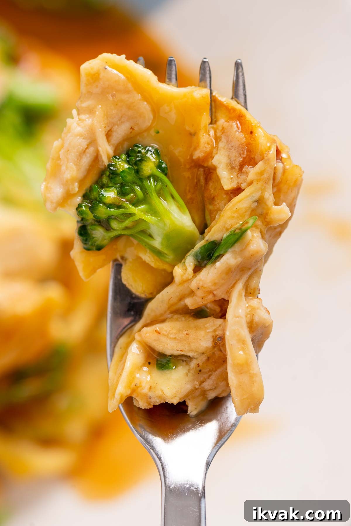 Keto Egg Foo Young Recipe: Low-Carb Chinese-Style Omelette 4 A fork with a bite of keto egg foo young with gravy on it.
