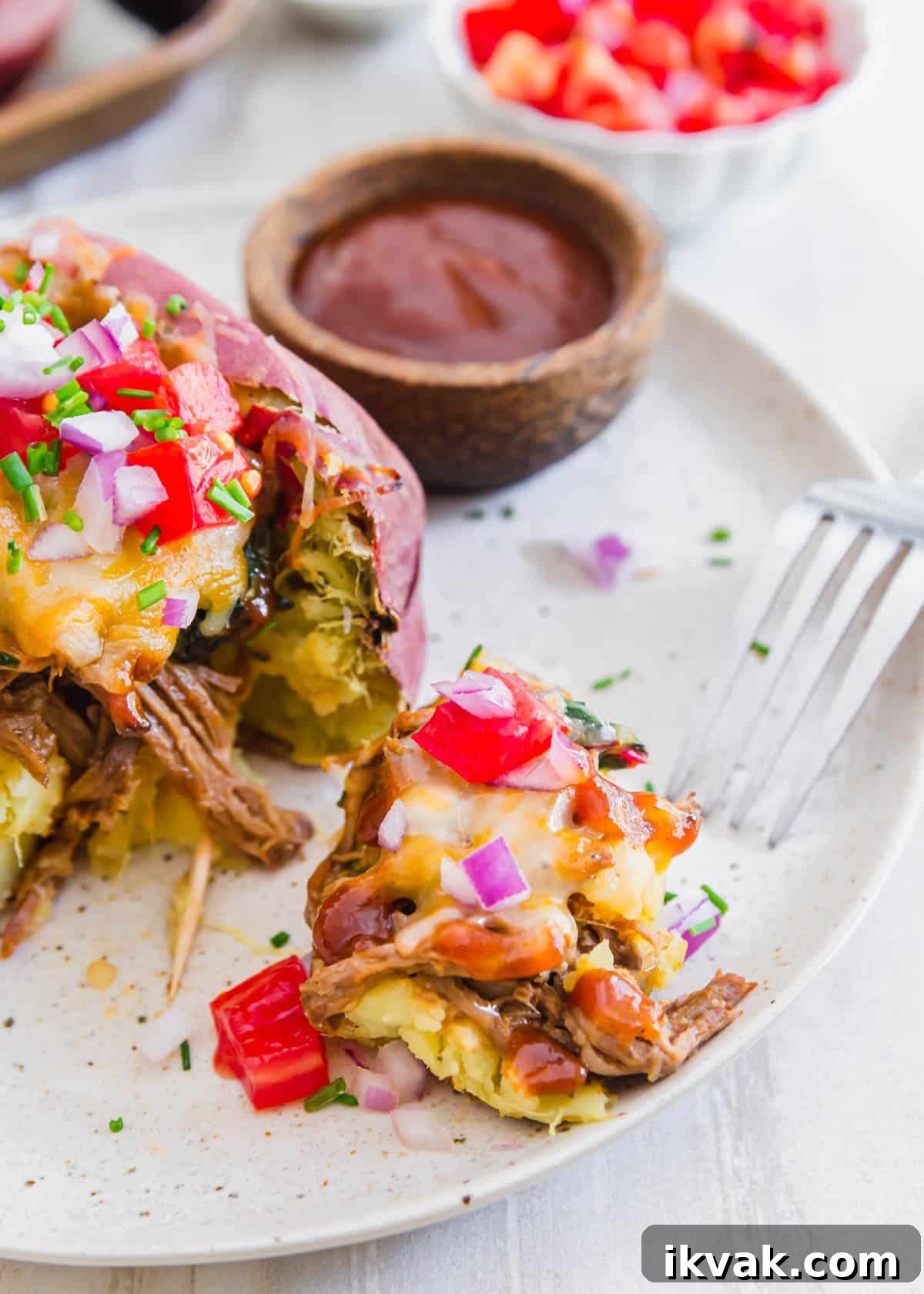 Loaded brisket baked potatoes served with BBQ sauce make an easy and delicious way to make a meal out of a baked potato!