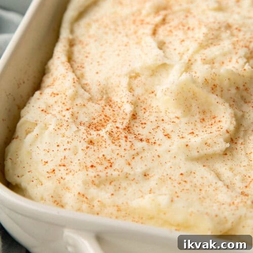 creamy mashed potatoes topped with a dusting of paprika.