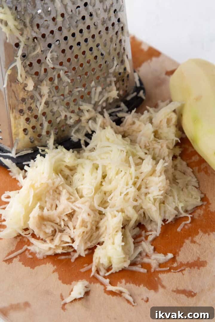 Crispy Potato Pancakes Recipe: Golden Hash Browns from Scratch 6 shredded potatoes next to a box grater.