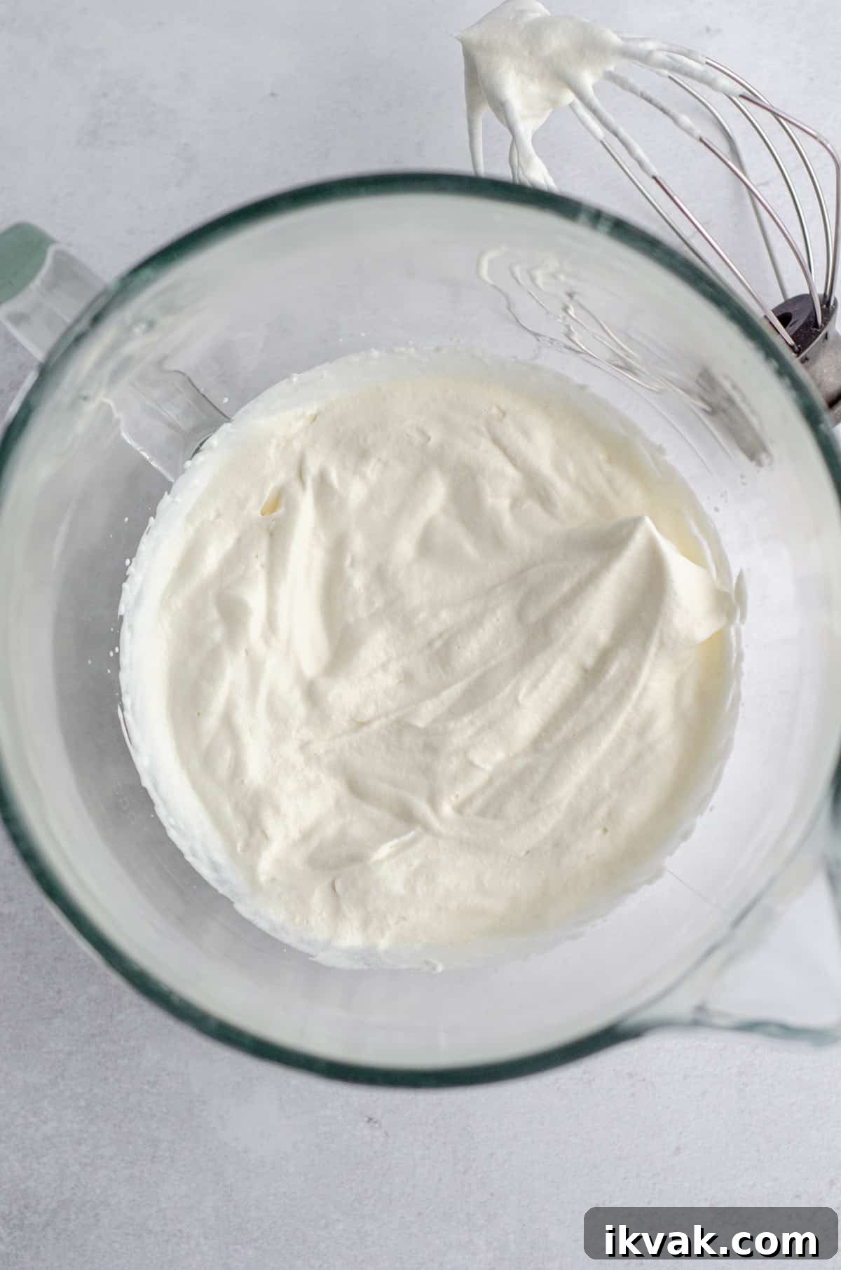 aerial photo of stiff peaks in homemade whipped cream in a glass bowl 