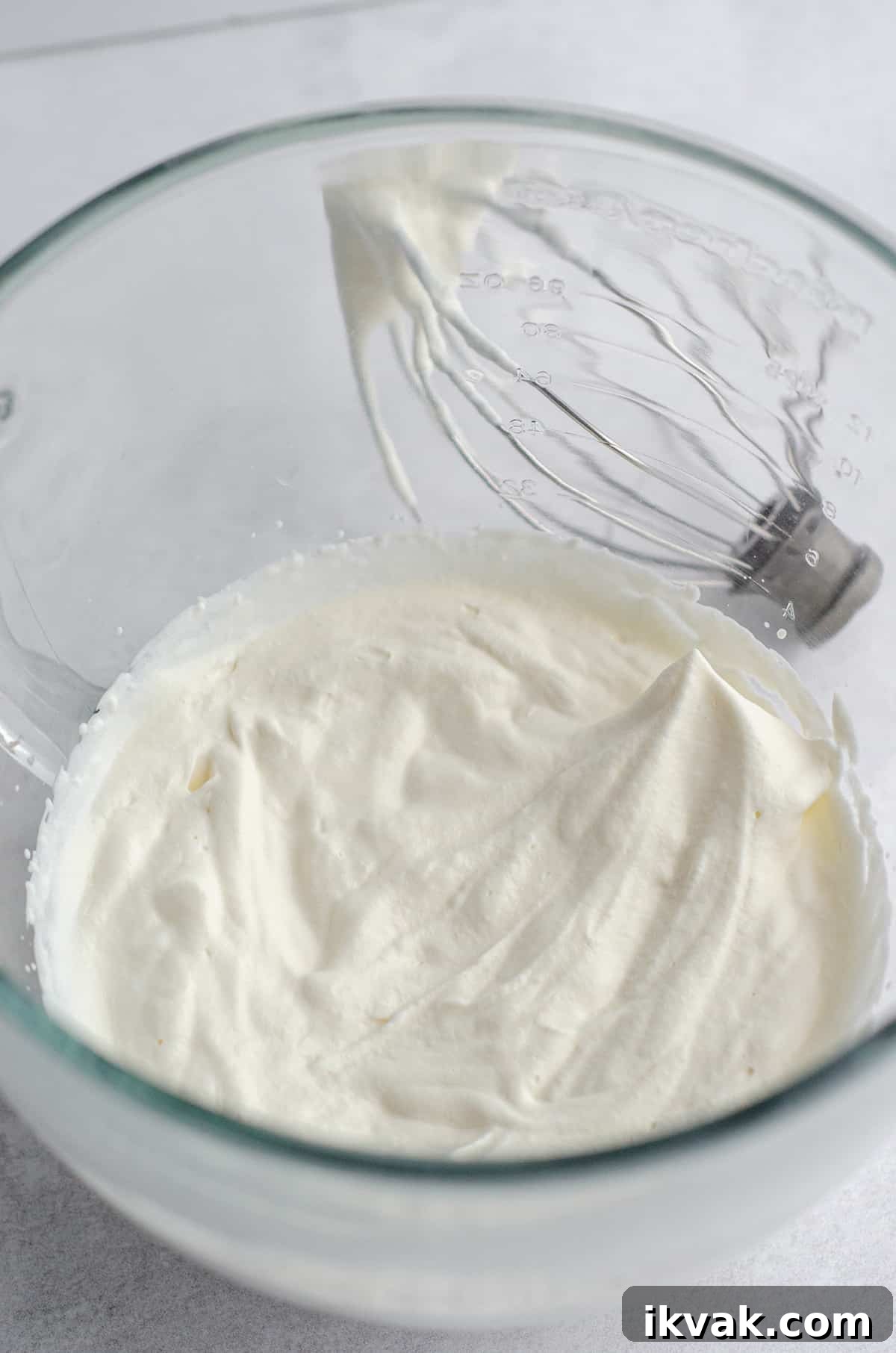 stiff peaks in homemade whipped cream in a glass bowl 