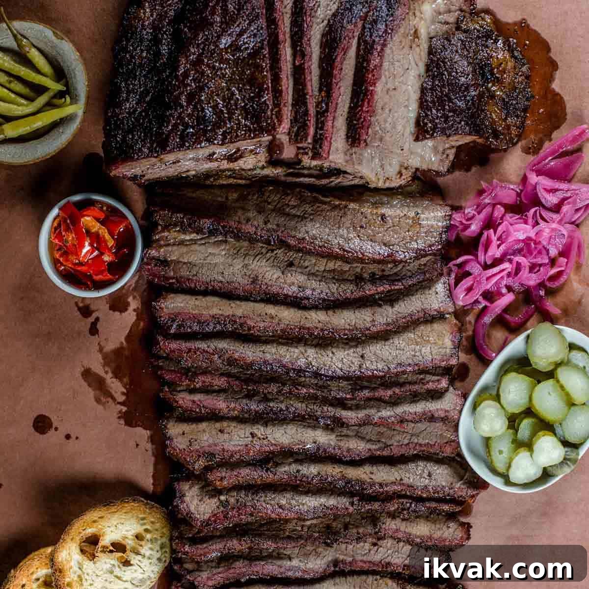 Carryover Cooking: What It Is and How It Affects Meat Doneness 5 Smoked brisket sliced on butcher paper with pickled vegetables.