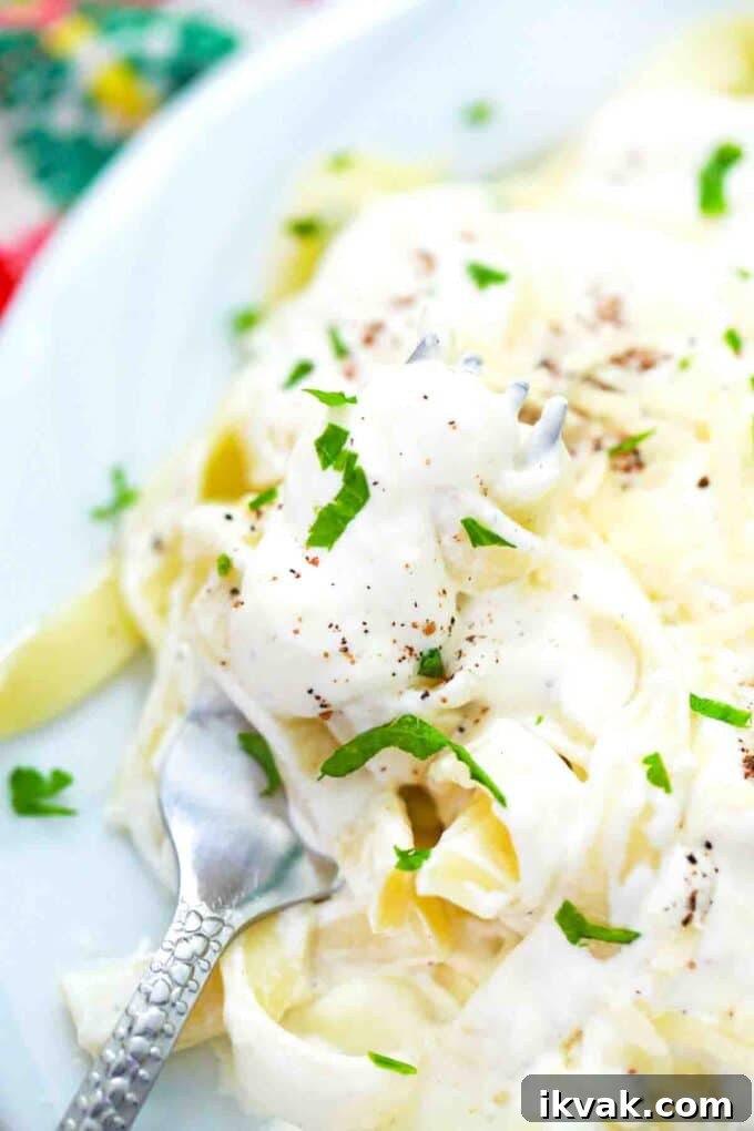 Creamy Homemade Alfredo Sauce Recipe for Pasta Night 11 a forkful of fettuccine in Alfredo sauce