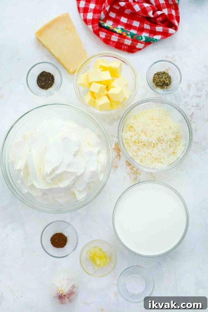 Creamy Homemade Alfredo Sauce Recipe for Pasta Night 4 overhead shot of ingredients for Alfredo sauce in bowls on a table