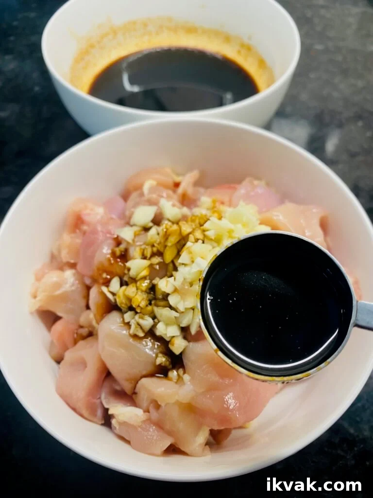 adding marinade to diced chicken