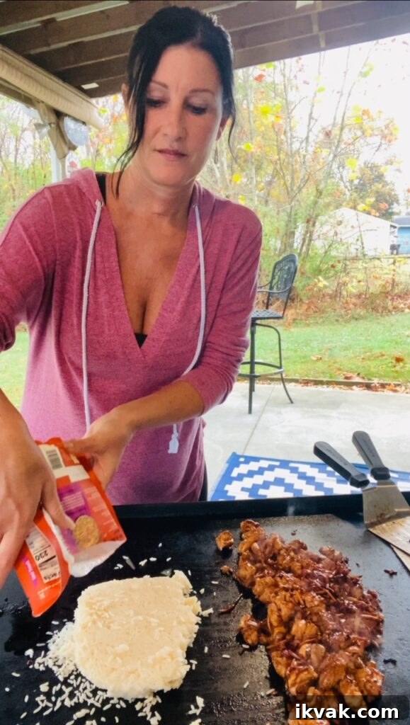 adding rice to the griddle for Blackstone Honey Lime Chicken Bowls