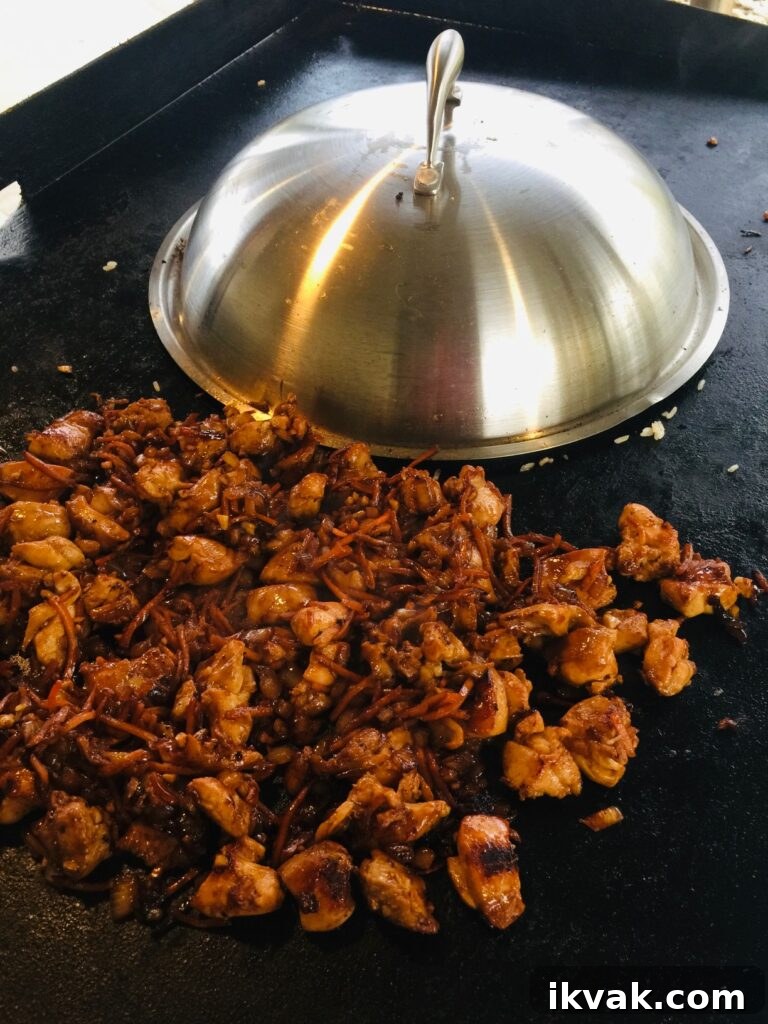 covering rice with melting dome while chicken cooks