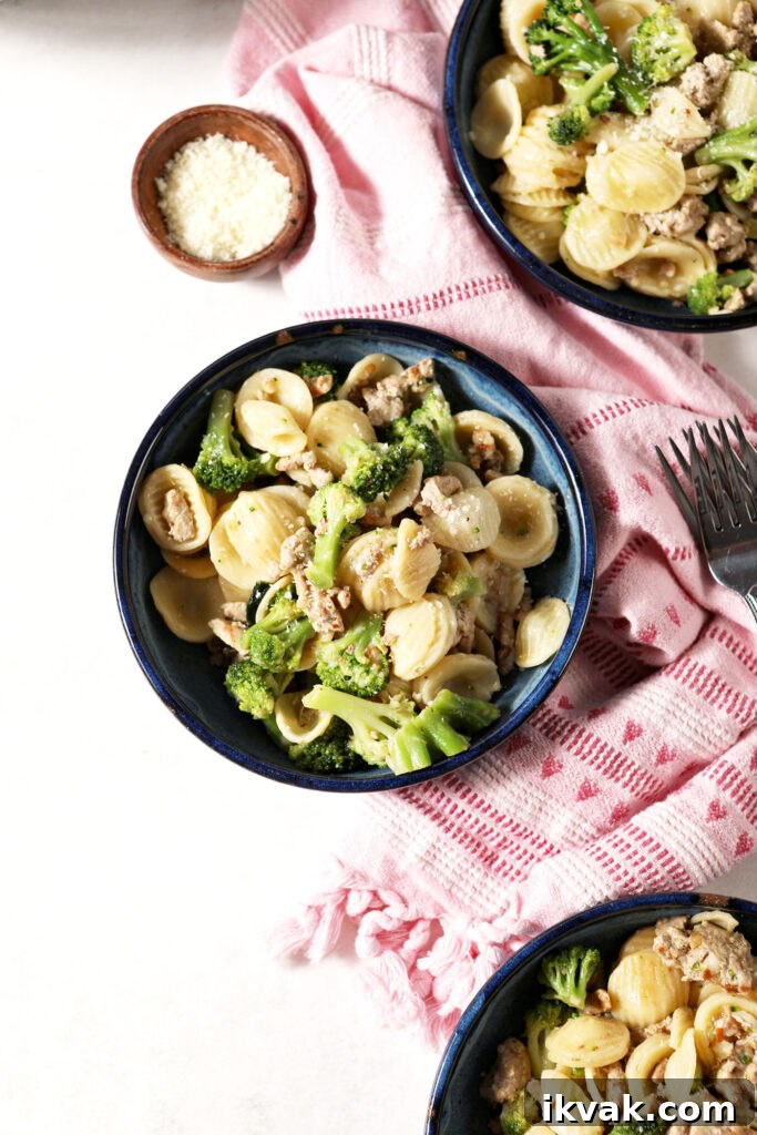 Orecchiette with Ground Turkey and Broccoli — Quick Weeknight Pasta 2 Overhead of three blue bowls holding servings Turkey Broccoli Orecchiette pasta on top of a pink linen on a marble surface