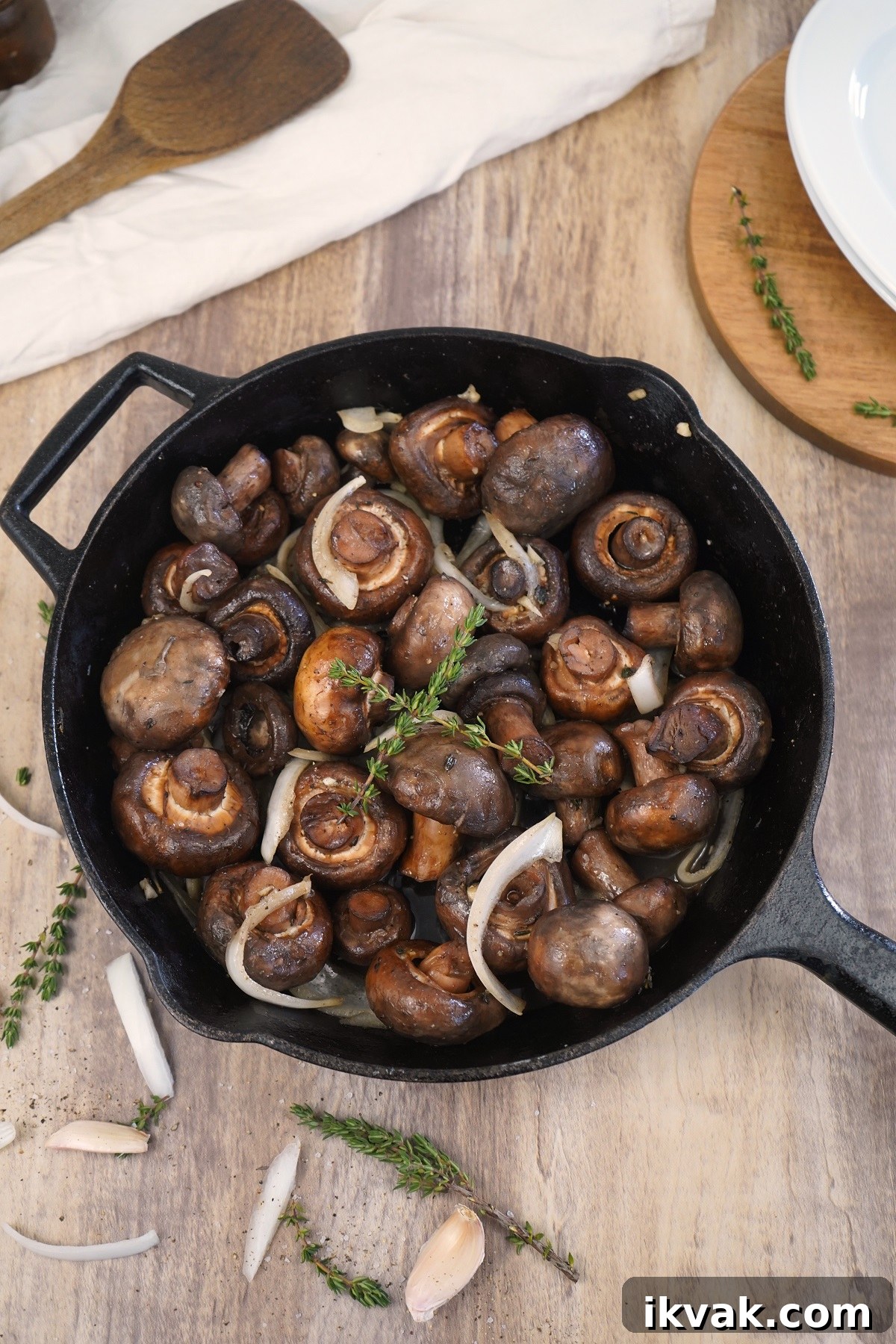 Smoked mushrooms in cast iron skillet with fresh thyme.