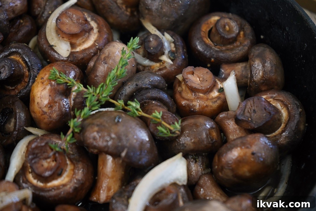 Garlic thyme smoked mushrooms close up in pan.