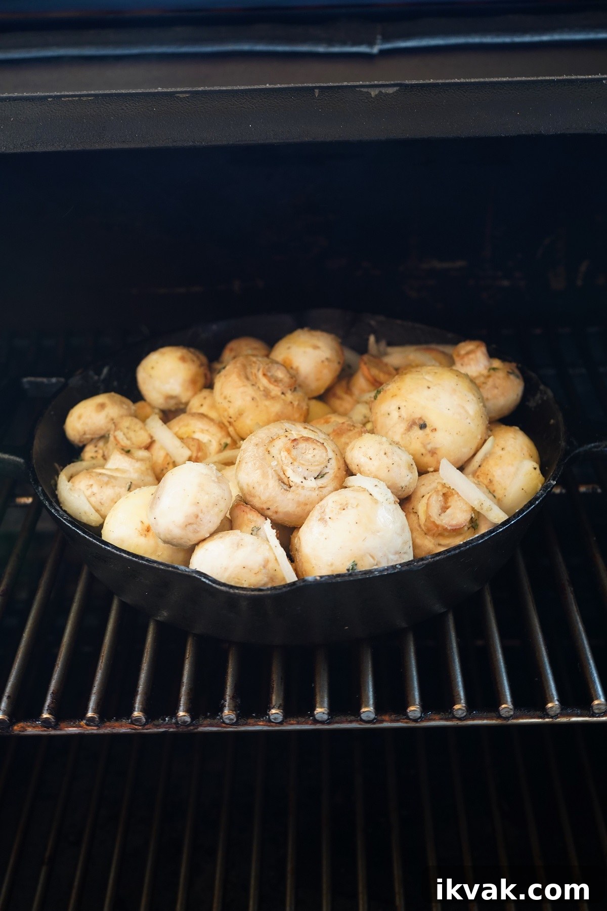Transfer the pan out to the preheated smoker and place onto the grates